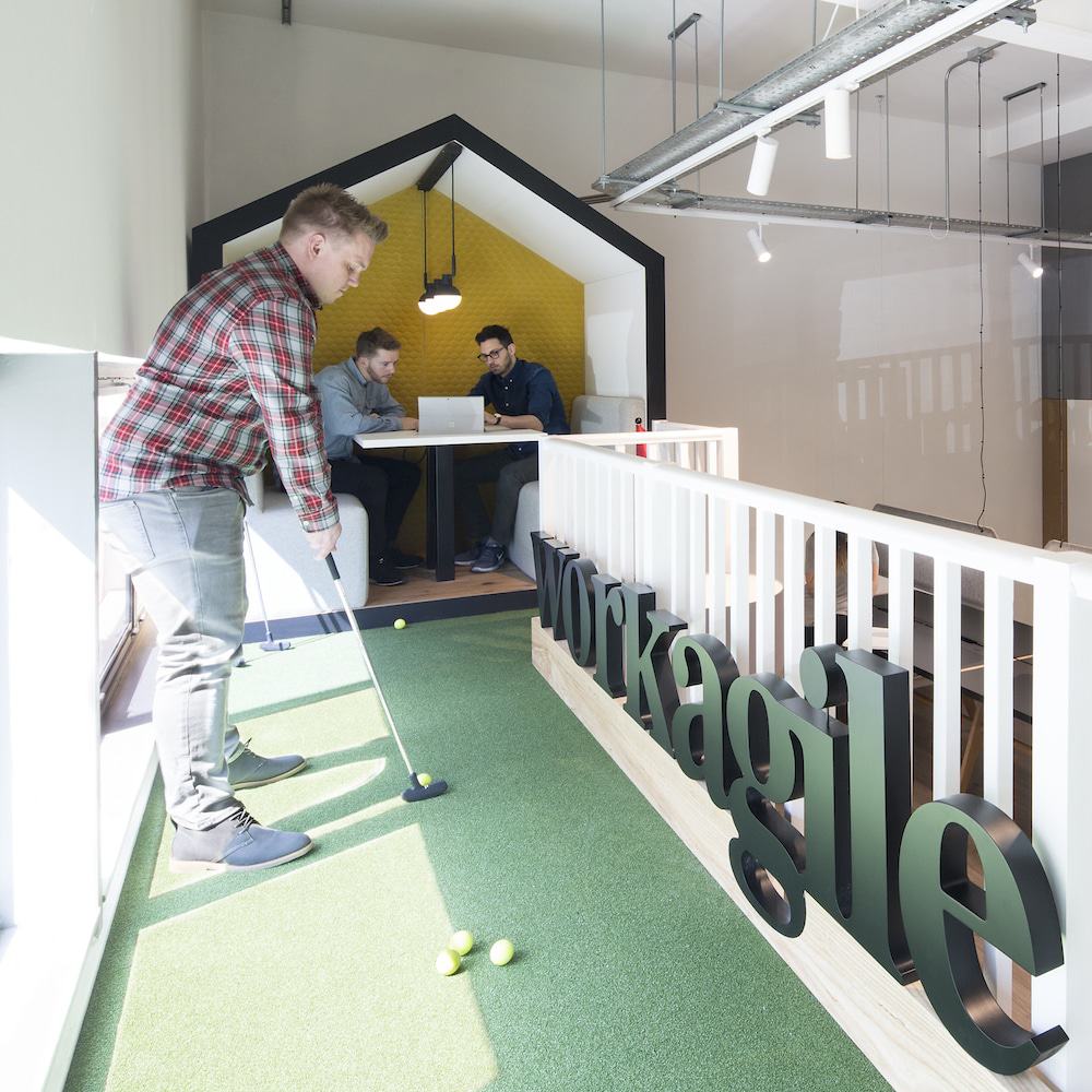 Man playing golf with Shack booth in background