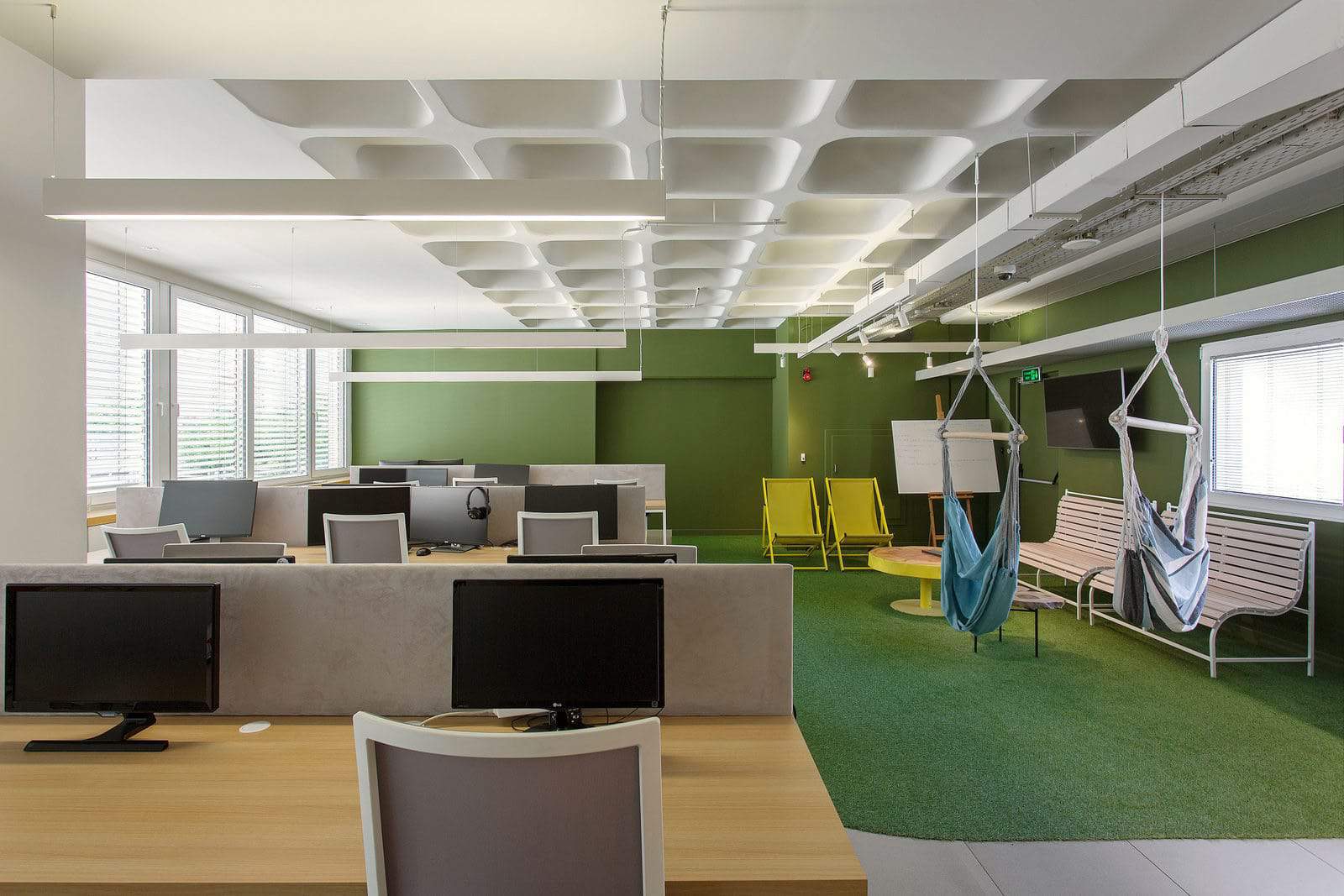 Ceiling suspended hammocks and artificial grass floor