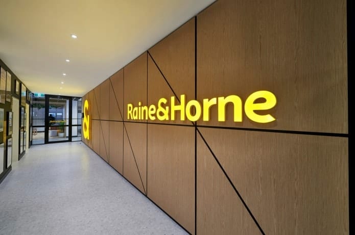 Raine and Horne logo on wall
