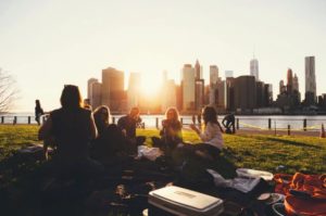People having a picnic with a skyline in the background