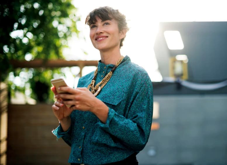 Woman outside using mobile phone - Blurred background