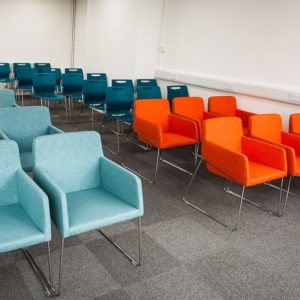 Touch armchairs by Workagile shown in a conference hall setting