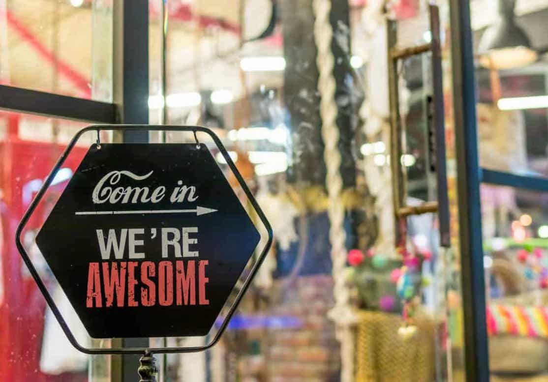 Sign saying "Come in we're awesome"