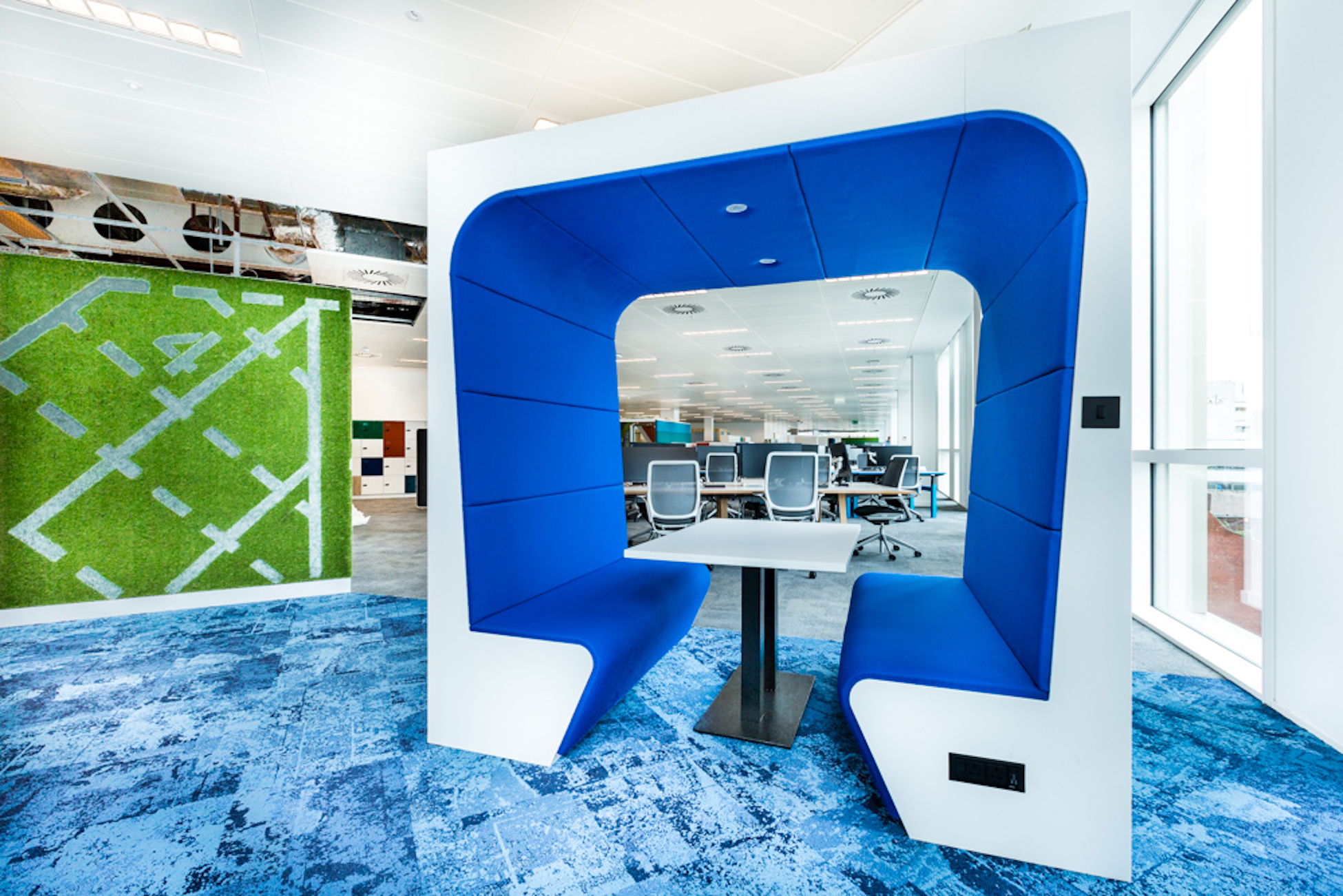 Workagile Snug meeting booth shown in white and blue in an office setting