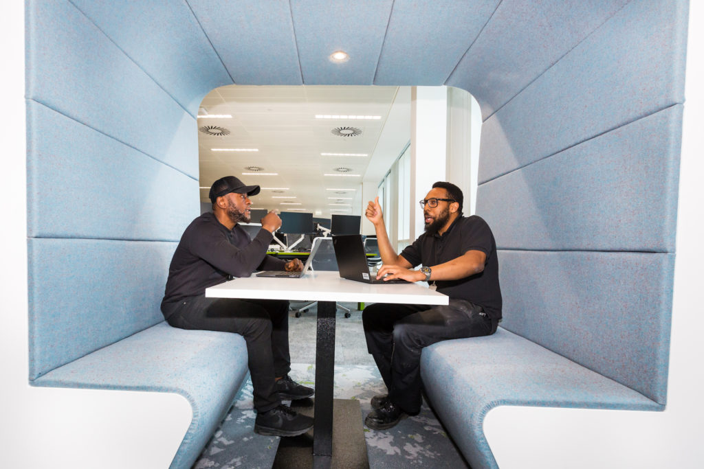Two men having a meeting in a Snug meeting booth by Workagile