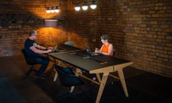 Two people working at Mutu 1100 desk in an industrial office setting