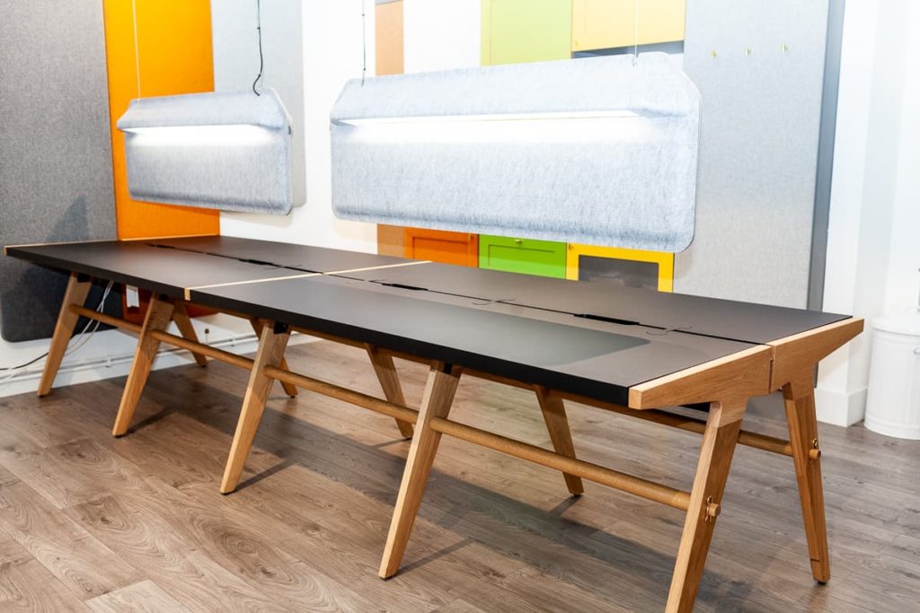 Two Mutu 1100 desks shown in a colourful office environment