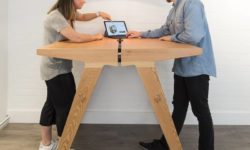 Two people working at a Mutu 1100 table in standing position