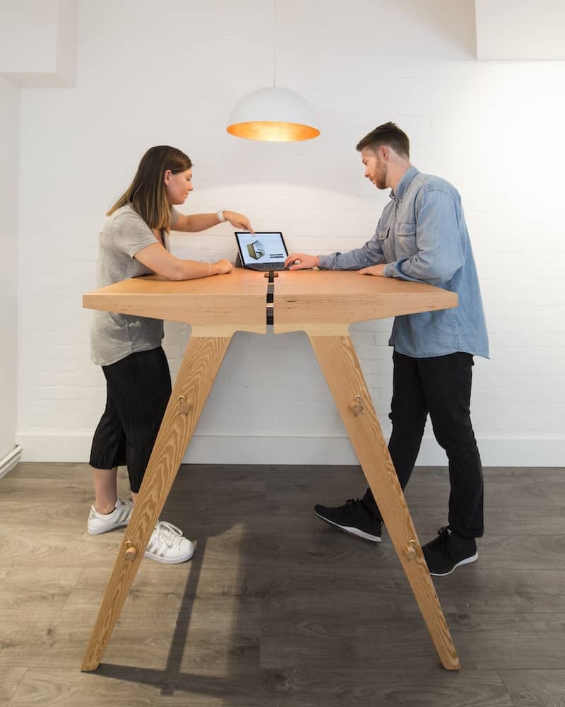 Two people working at a Mutu 1100 table in standing position
